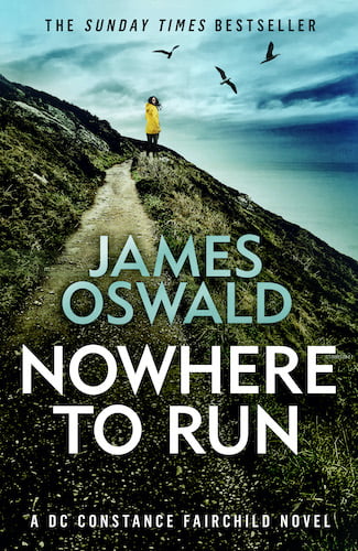 Cover image for Nowhere To Run, book three in the Constance Fairchild series by James Oswald. Image shows a woman in a bright yellow coat, looking back towards the camera as she stands on a clifftop path. Gulls fly above her head and the see merges with the clouds in the background